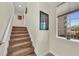 Modern carpeted staircase with a window overlooking the backyard at 550 Yardarm Ln, Longboat Key, FL 34228