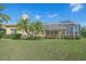 Landscaped backyard with pool and screened enclosure at 5655 Eastwind Dr, Sarasota, FL 34233