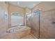 Spa-like bathroom with a walk-in shower and soaking tub at 5655 Eastwind Dr, Sarasota, FL 34233