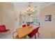 Open dining room with a large table and red chairs at 5655 Eastwind Dr, Sarasota, FL 34233