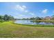 Serene lake view with lush green landscaping at 5655 Eastwind Dr, Sarasota, FL 34233