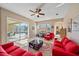 Spacious living room with pool view and red sofas at 5655 Eastwind Dr, Sarasota, FL 34233