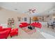 Bright living room with red couches and a large TV at 5655 Eastwind Dr, Sarasota, FL 34233