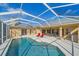 Relaxing screened pool with patio and lounge chairs at 5655 Eastwind Dr, Sarasota, FL 34233