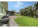 Landscaped backyard with grill and canal views at 5830 Gulf Of Mexico Dr, Longboat Key, FL 34228