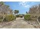 House with a gated entrance and landscaping at 5830 Gulf Of Mexico Dr, Longboat Key, FL 34228