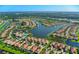 Aerial view of community, showcasing homes and lake at 5890 Guarino Dr, Sarasota, FL 34238