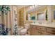 Clean bathroom with a shower/tub combo, tiled walls, and light wood vanity at 5890 Guarino Dr, Sarasota, FL 34238