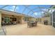 Spacious covered patio with seating area and built-in grill at 5890 Guarino Dr, Sarasota, FL 34238