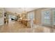 Dining area with a farmhouse table, connecting to kitchen and living room at 5890 Guarino Dr, Sarasota, FL 34238