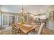 Farmhouse-style dining room with a view into the kitchen and living area at 5890 Guarino Dr, Sarasota, FL 34238