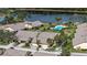 Aerial view of community with homes surrounding a pool and lake at 5911 Doral Dr, Sarasota, FL 34243