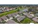 Aerial view of a villa nestled in a community by a golf course at 5911 Doral Dr, Sarasota, FL 34243