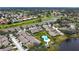 Aerial view showing home's location in community near pool and lake at 5911 Doral Dr, Sarasota, FL 34243