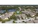 Aerial view of community, showcasing homes, pool, and lake at 5911 Doral Dr, Sarasota, FL 34243