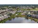 Aerial view showcasing a villa community near a lake at 5911 Doral Dr, Sarasota, FL 34243