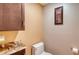 Powder room with granite countertop and toilet at 5911 Doral Dr, Sarasota, FL 34243