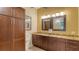 Elegant bathroom with granite countertops and dark wood cabinets at 5911 Doral Dr, Sarasota, FL 34243