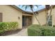 Front entry with screen door and landscaping at 5911 Doral Dr, Sarasota, FL 34243