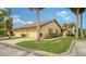 Exterior of a villa with two-car garage and landscaping at 5911 Doral Dr, Sarasota, FL 34243