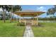 Quaint gazebo with seating area overlooking a lake at 5911 Doral Dr, Sarasota, FL 34243