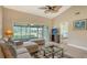 Bright living room with vaulted ceiling, comfy seating, and view of the backyard at 5911 Doral Dr, Sarasota, FL 34243