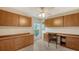 Home office with built-in cabinetry and wood desk at 5911 Doral Dr, Sarasota, FL 34243