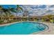 Community pool with plenty of lounge chairs and umbrellas at 5911 Doral Dr, Sarasota, FL 34243