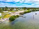 An aerial view showcasing waterfront living with a dock and serene surroundings at 631 43Rd Street W Blvd, Palmetto, FL 34221