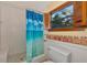 Small bathroom with shower and a blue ocean shower curtain at 631 43Rd Street W Blvd, Palmetto, FL 34221