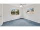 Bright bedroom with large windows and blue carpeting at 6424 18Th E Ave, Bradenton, FL 34208