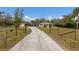 Long gravel driveway with gated entrance at 6424 18Th E Ave, Bradenton, FL 34208