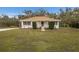 Ranch-style home with a large yard and mature trees at 6424 18Th E Ave, Bradenton, FL 34208