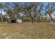 White outbuilding with green trim and covered storage area at 6424 18Th E Ave, Bradenton, FL 34208