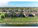 Aerial view of lakefront homes with tile roofs and lush landscaping at 6579 Willowshire Way, Bradenton, FL 34212