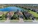 Aerial view of three homes with tile roofs and paved driveways at 6579 Willowshire Way, Bradenton, FL 34212