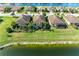 Aerial view of lakefront homes in a tranquil community setting at 6579 Willowshire Way, Bradenton, FL 34212