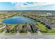 Community view showcasing a lake and many homes at 6579 Willowshire Way, Bradenton, FL 34212