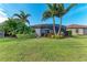 Landscaped backyard with screened patio and lush tropical plants at 6579 Willowshire Way, Bradenton, FL 34212