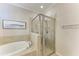 Bathroom with a walk-in shower and a soaking tub at 6579 Willowshire Way, Bradenton, FL 34212