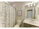 Stylish bathroom with modern vanity and geometric shower curtain at 6579 Willowshire Way, Bradenton, FL 34212