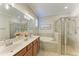 Double vanity bathroom with soaking tub and walk-in shower at 6579 Willowshire Way, Bradenton, FL 34212