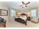 Spacious main bedroom with a ceiling fan and ensuite bathroom at 6579 Willowshire Way, Bradenton, FL 34212