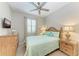 Guest bedroom with a queen-size bed and adjacent bathroom at 6579 Willowshire Way, Bradenton, FL 34212