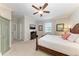 Bright bedroom with a king-size bed and ceiling fan at 6579 Willowshire Way, Bradenton, FL 34212