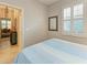 Charming bedroom with a bed, window shutters and view into another room at 6579 Willowshire Way, Bradenton, FL 34212