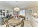 Bright dining room with a round wooden table, six chairs, and decorative accents at 6579 Willowshire Way, Bradenton, FL 34212