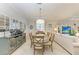 Bright dining room features a round wooden table with six chairs, and a view to the living room at 6579 Willowshire Way, Bradenton, FL 34212