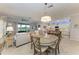 Open concept dining room with table and chairs, offering a view of kitchen and living room at 6579 Willowshire Way, Bradenton, FL 34212