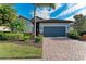 Single-Gathering home with gray garage door and palm trees at 6579 Willowshire Way, Bradenton, FL 34212